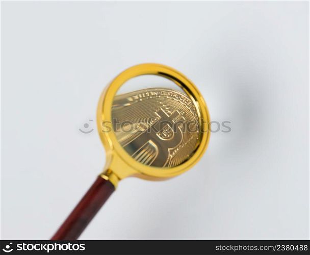 Viewing and the increase in bitcoin through a magnifying glass. electronic money. coins are bitcoin and litecoin