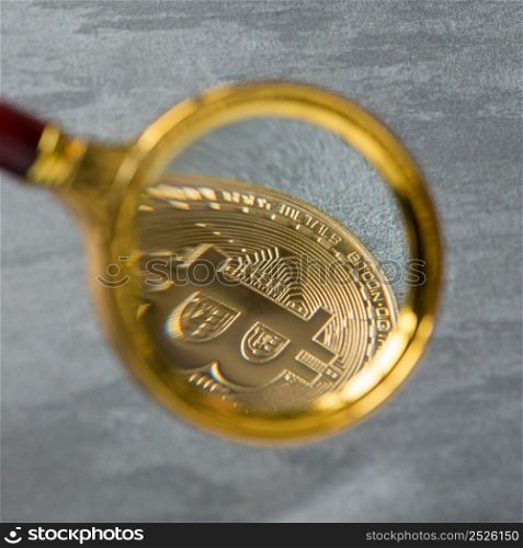 Viewing and the increase in bitcoin through a magnifying glass. electronic money. coins are bitcoin and litecoin