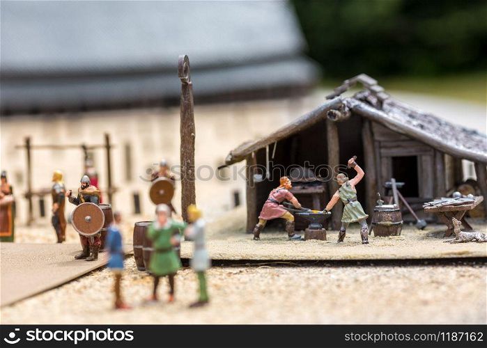 Viking settlement miniature outdoor, people fugurines, europe. Ancient european village, medieval Scandinavia, traditional scandinavian architecture, diorama. Viking settlement miniature, people fugurines