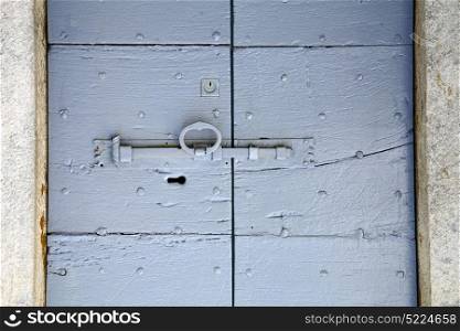 villadosia varese abstract rusty brass brown knocker in a door curch closed wood lombardy italy