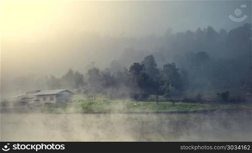 village among mountain and fog. Cottage in the village among mountain and fog