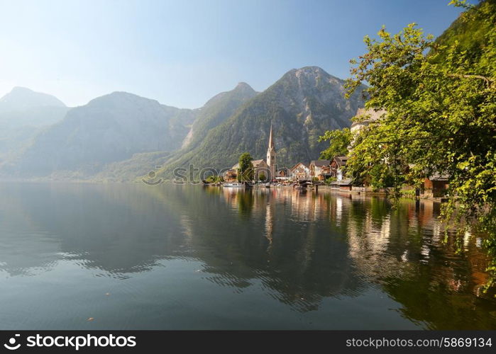 village at foot of mountains on lake shore