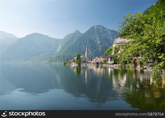 village at foot of mountains on lake shore