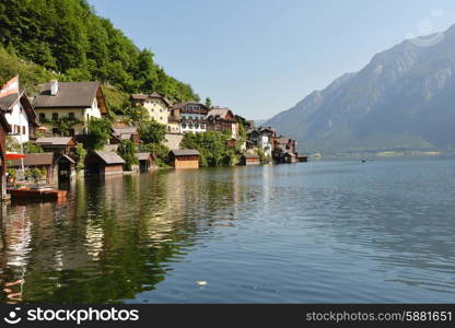 village at foot of mountains on lake shore