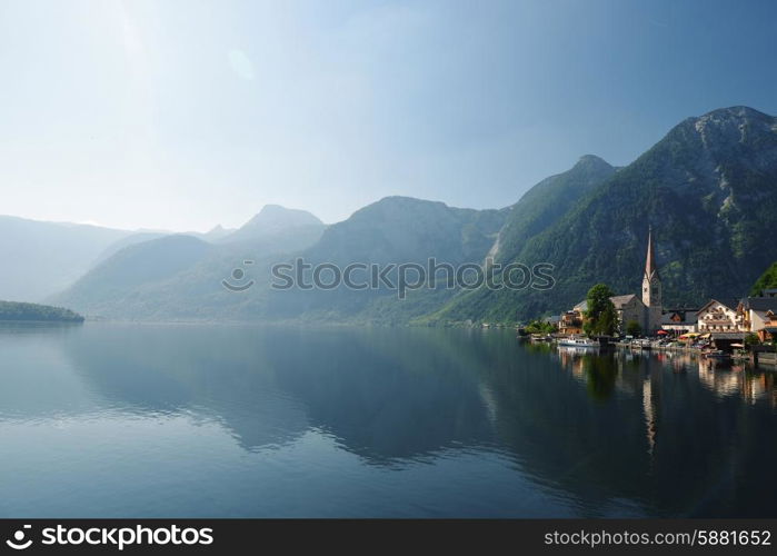 village at foot of mountains on lake shore