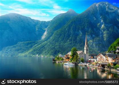village at foot of mountains on lake shore