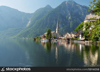 village at foot of mountains on lake shore