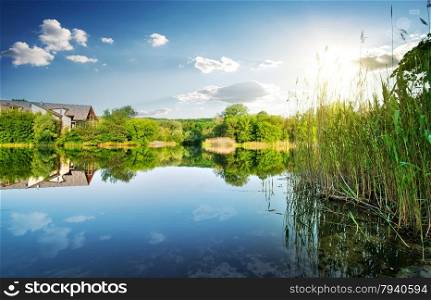 Village by the calm river in spring