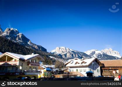 Village In Italian Alps Against Blue Clear Sky. Winter Travel Series.
