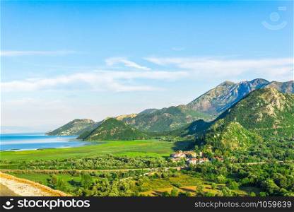 Village in mountains near Skadar lake at sunny summer day, Montenegro. Mountains and Skadar lake