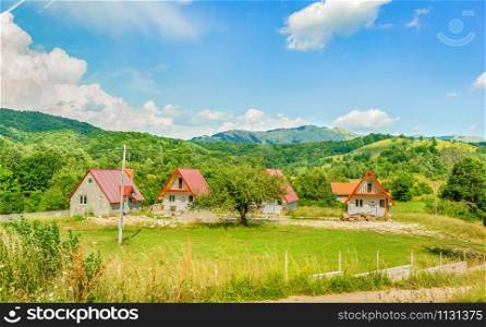 Village in mountains of Montenegro at sunny summer day. Village in mountains
