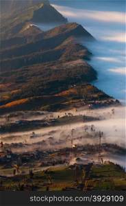 Village next to volcano Bromo, covered in fog
