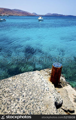 village rusty metal yacht spain harbor pier boat in the blue sky arrecife teguise lanzarote