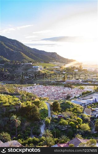 Village under the mountain against clear sky at sunset in Spain.. Village under the mountain against clear sky at sunset