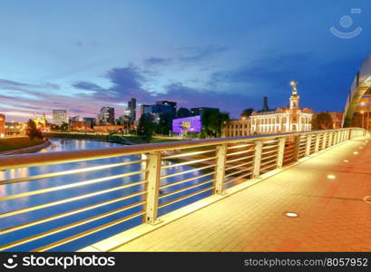 Vilnius. Mindaugas Bridge across Neris.. Iron arched Mindaugas Bridge across Neris River in Vilnius with night lighting. Lithuania.