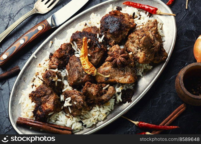 Vinegar marinated pork braised in Indian spices, vindaloo.. Pork vindaloo, a popular Indian dish.