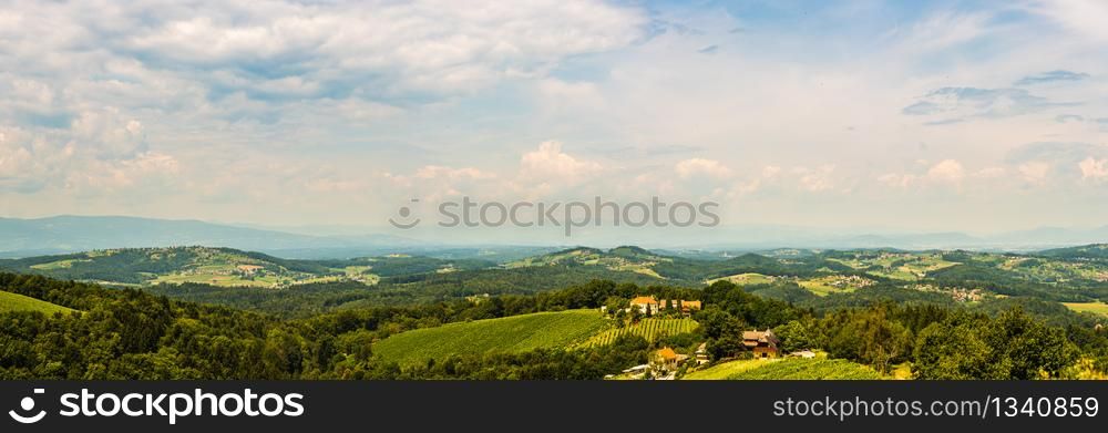 Vineyards panorama Leibnitz area famous destination wine country, south Styria, Austria. Tourist destination. Green hills of grape crops and mountains.. Panorama of Leibnitz area famous destination wine country, Kogelberg south Styria, Austria.