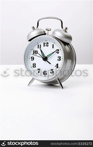 vintage alarm clock in good condition on grey background