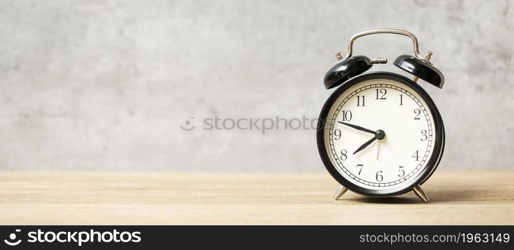 Vintage alarm clock on wooden table and copy space for text. Activity, daily routine, morning, workout and Work life balance concept