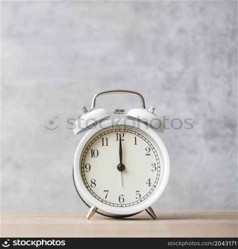 Vintage alarm clock on wooden table background and copy space for text. Activity, daily routine, morning, countdown, workout and Work life balance concept