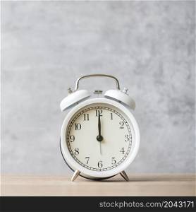 Vintage alarm clock on wooden table background and copy space for text. Activity, daily routine, morning, countdown, workout and Work life balance concept