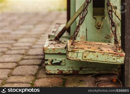 Vintage, antique objects concept. Old fashioned rotten green wooden weighing machine in sunlight. Old fashioned rotten wooden weighing machine