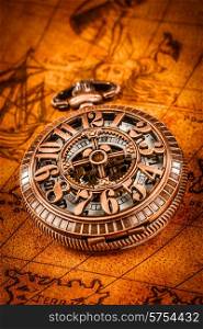 Vintage Antique pocket watch on an ancient world map in 1565..