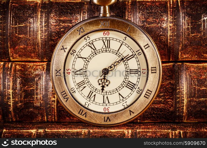 Vintage Antique pocket watch on the background of old books