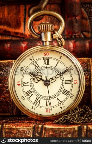 Vintage Antique pocket watch on the background of old books