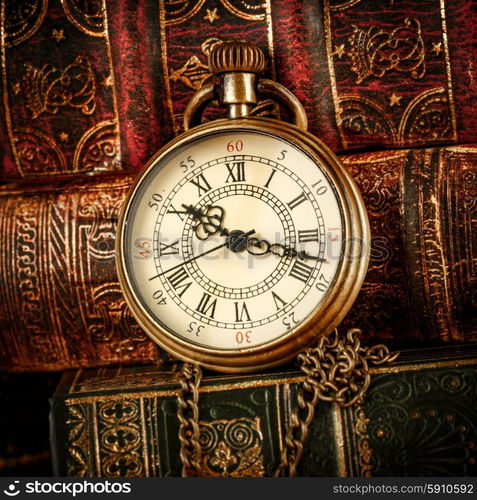 Vintage Antique pocket watch on the background of old books