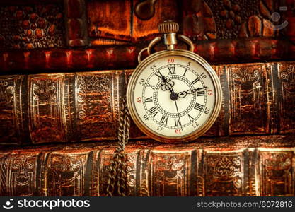 Vintage Antique pocket watch on the background of old books