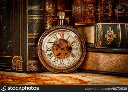 Vintage Antique pocket watch on the background of old books