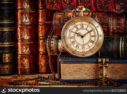 Vintage Antique pocket watch on the background of old books