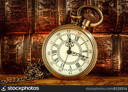 Vintage Antique pocket watch on the background of old books