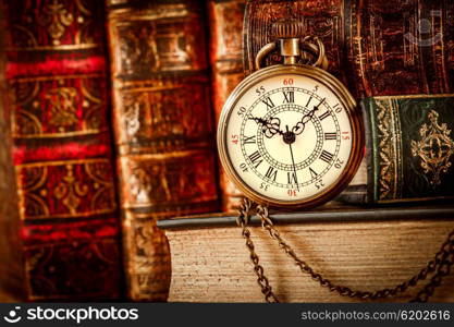 Vintage Antique pocket watch on the background of old books