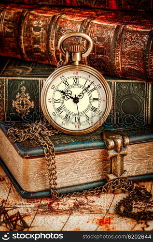 Vintage Antique pocket watch on the background of old books