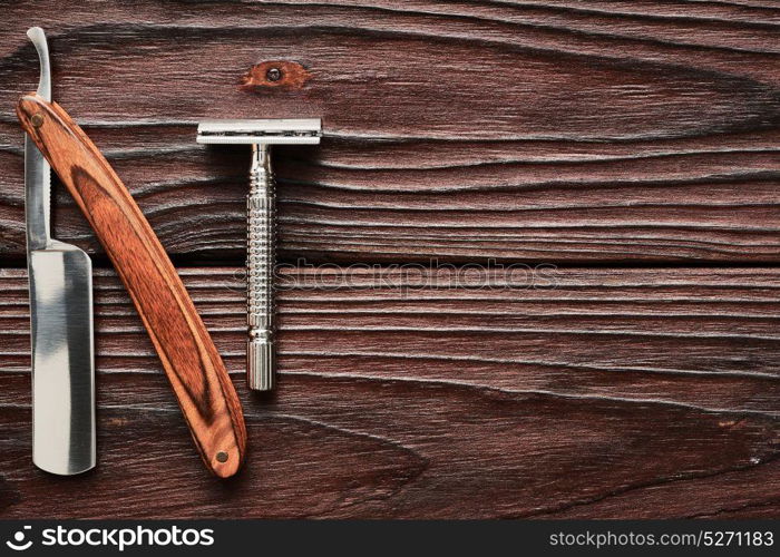 Vintage barber shop razor tools on old wooden background