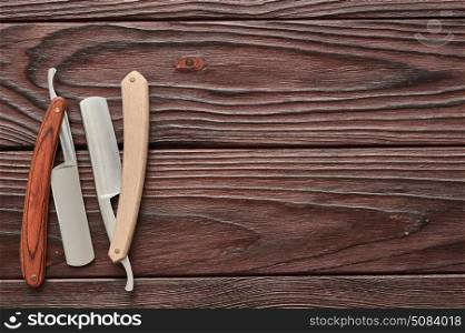 Vintage barber shop straight razor tool on wooden background. Vintage barber shop straight razor tool on old wooden background