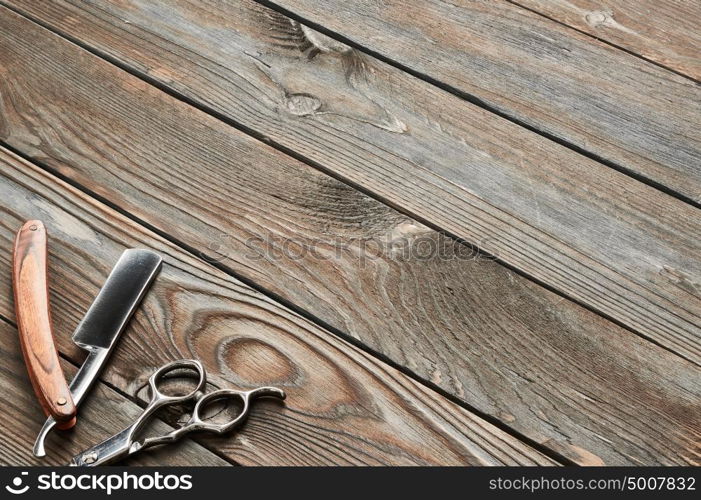 Vintage barber shop tools on old wooden background