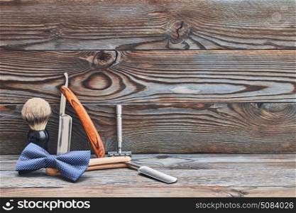 Vintage barber shop tools on wooden background. Vintage barber shop tools on old wooden background with copy space