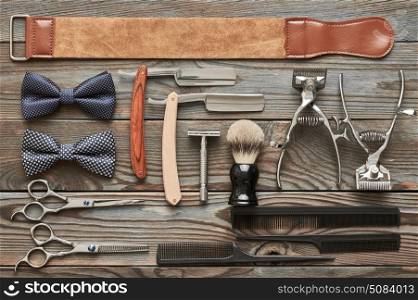 Vintage barber shop tools on wooden background. Vintage barber shop tools on old wooden background