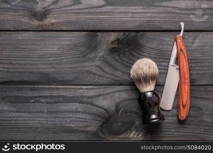 Vintage barber shop tools on wooden background. Vintage barber shop tools on old wooden background