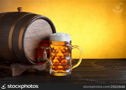 Vintage beer barrel with huge beer glass on wooden table still life, copy space