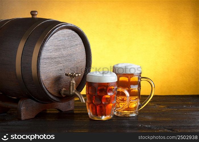 Vintage beer barrel with two beer glasses on wooden table still life with copy space