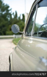 Vintage beige color car. Small old car. Italian car. Sunny day