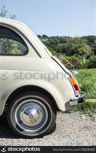 Vintage beige color car. Small old car. Italian car. Sunny day