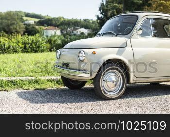 Vintage beige color car. Small old car. Italian car. Sunny day