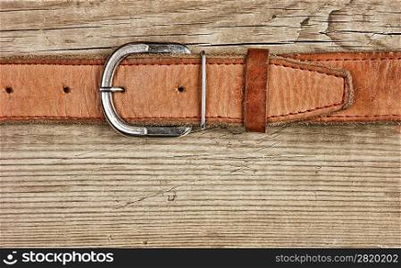 vintage belt buckle on a old wooden board