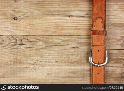 vintage belt buckle on a old wooden board