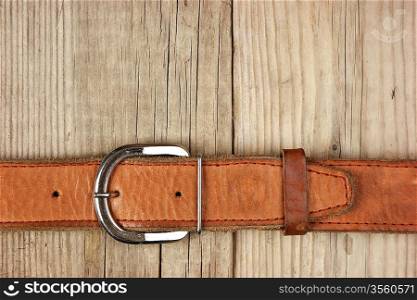 vintage belt buckle on a old wooden board